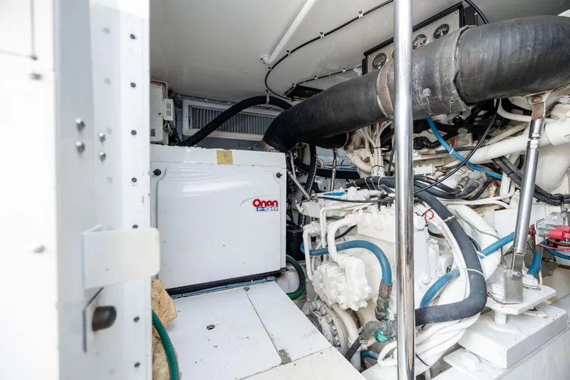 Wet Hooker Yacht Photos Pics Engine room of 2003 Hatteras 60 Convertible yacht with Onan generator and complex piping system.