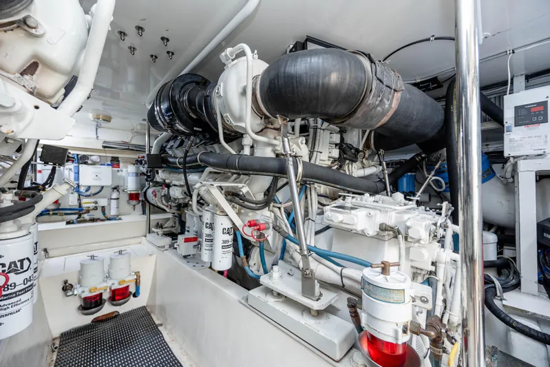 Wet Hooker Yacht Photos Pics Engine room of 2003 Hatteras 60 Convertible yacht, showcasing mechanical components and systems.
