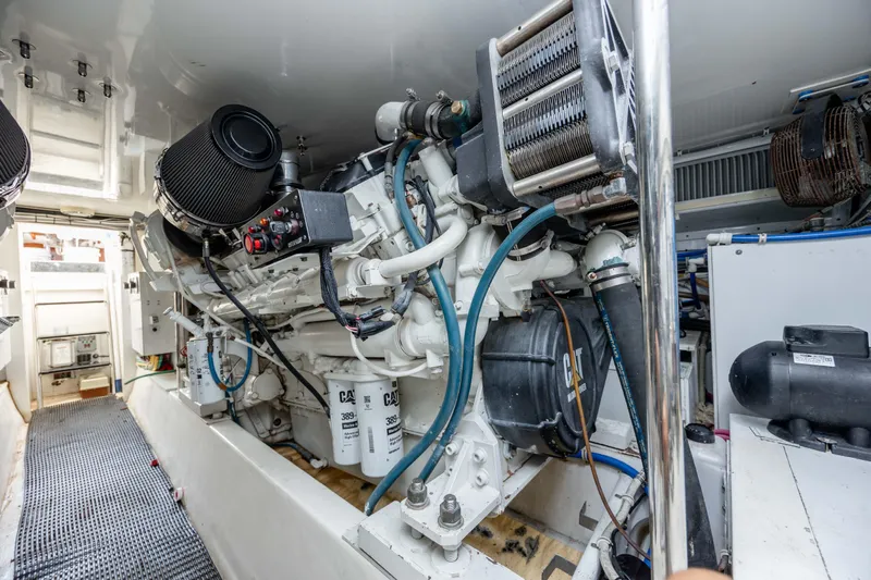Wet Hooker Yacht Photos Pics Engine room of 2003 Hatteras 60 Convertible yacht, showcasing mechanical components.