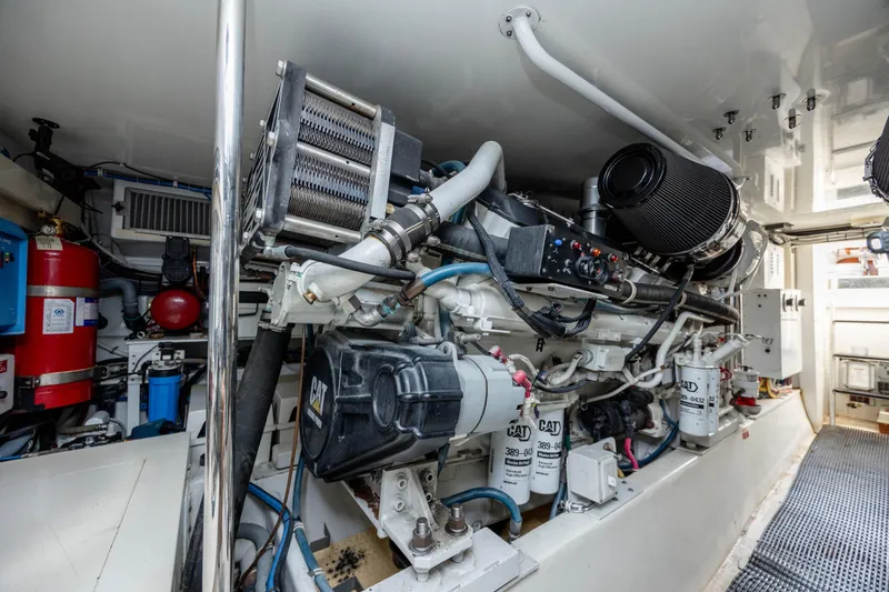 Wet Hooker Yacht Photos Pics Engine room of 2003 Hatteras 60 Convertible yacht, showcasing mechanical components.