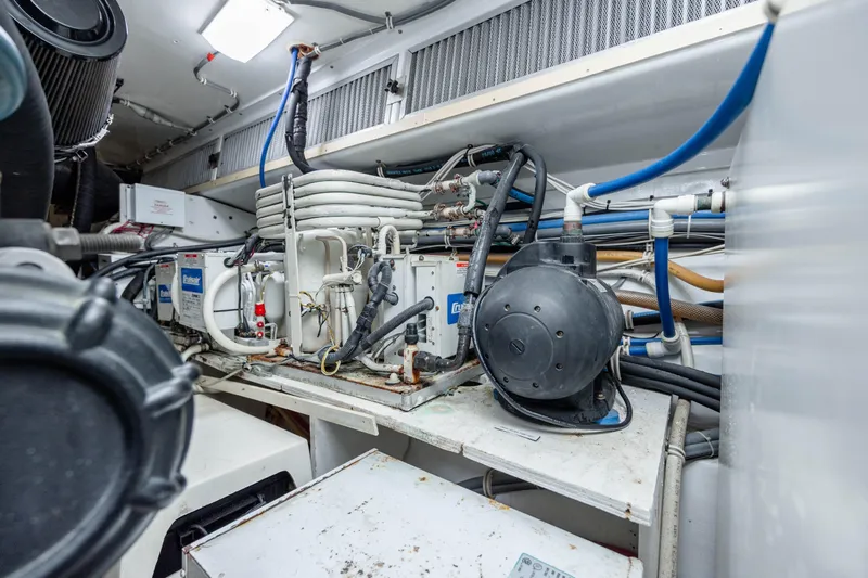 Wet Hooker Yacht Photos Pics Engine room of 2003 Hatteras 60 Convertible yacht with mechanical equipment and piping.