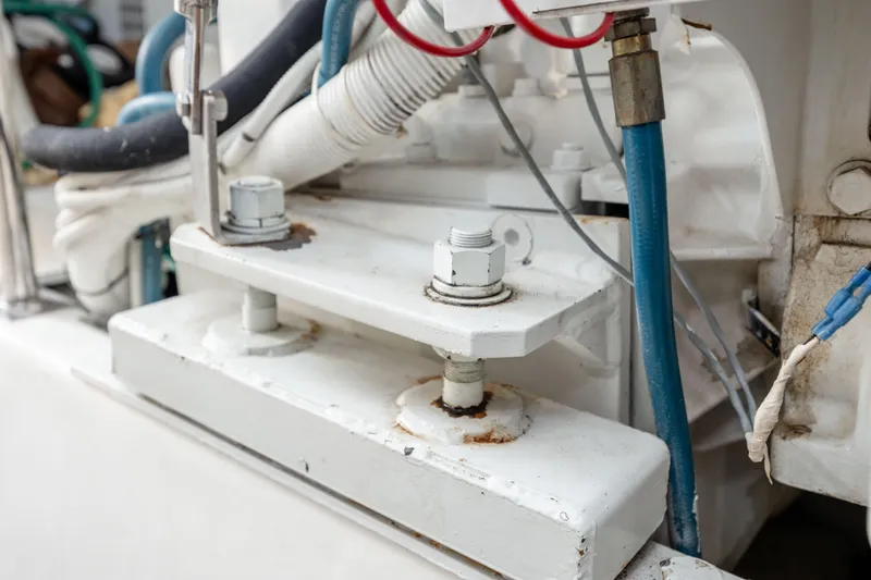 Wet Hooker Yacht Photos Pics Engine components of a 2003 Hatteras 60 Convertible boat, featuring bolts and hoses.