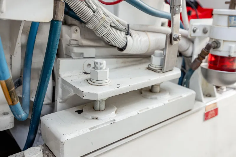 Wet Hooker Yacht Photos Pics Engine compartment of 2003 Hatteras 60 Convertible with visible bolts and wiring.