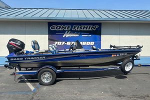 2005 Bass Tracker Pro Team 175 boat with Mercury engine, parked outside dealership.