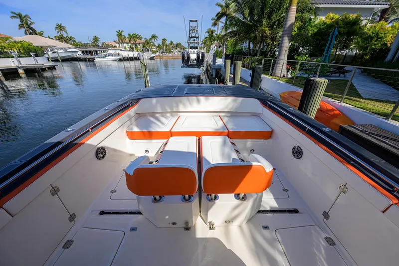  Yacht Photos Pics 2022 World Cat 400 CC-X boat interior with orange seating, docked in a scenic marina.