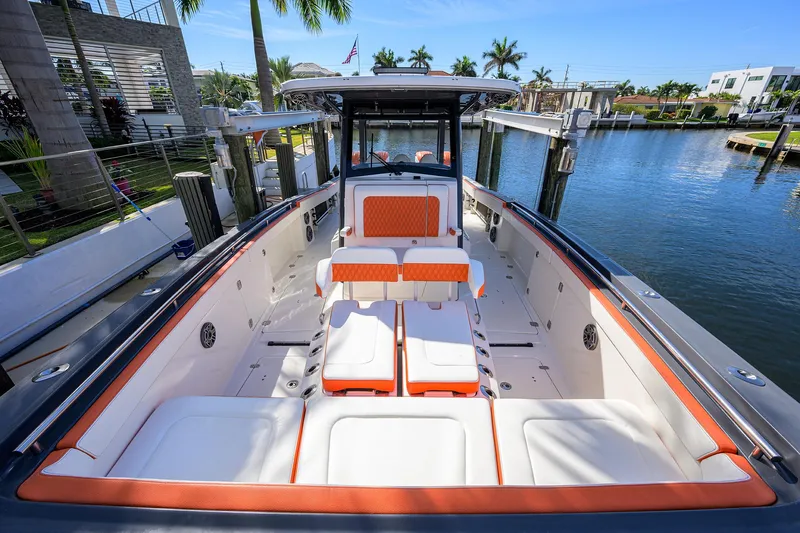  Yacht Photos Pics 2022 World Cat 400 CC-X boat with spacious seating and modern design in a marina setting.