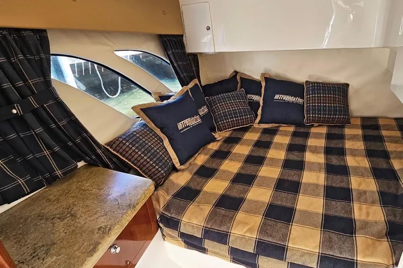 Intrepidation Yacht Photos Pics 2009 Intrepid 430 Sport Yacht cabin with plaid bedding and matching pillows.