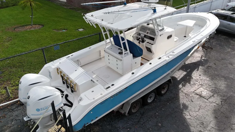  Yacht Photos Pics 2015 Edgewater 320CC boat with dual Yamaha engines on a trailer.