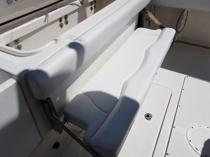  Yacht Photos Pics 2015 Edgewater 320CC boat with white cushioned seating and storage compartment.