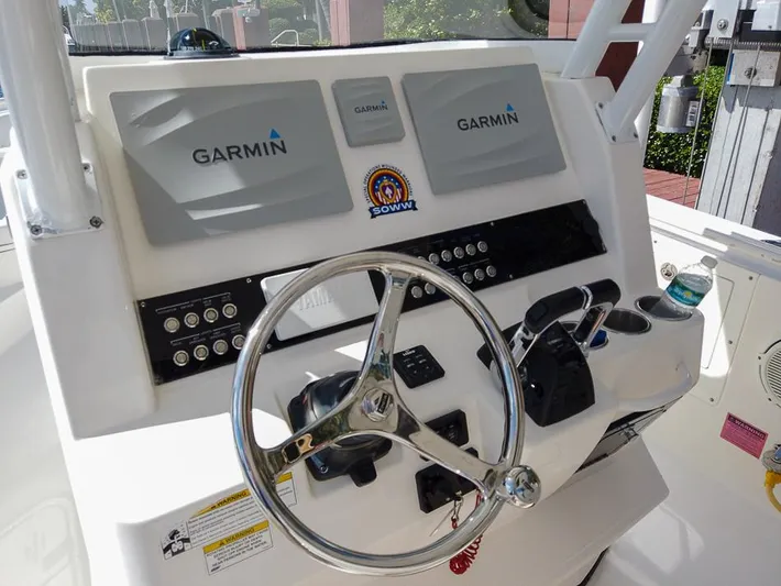  Yacht Photos Pics 2015 Edgewater 320CC boat dashboard with Garmin navigation system and steering wheel.