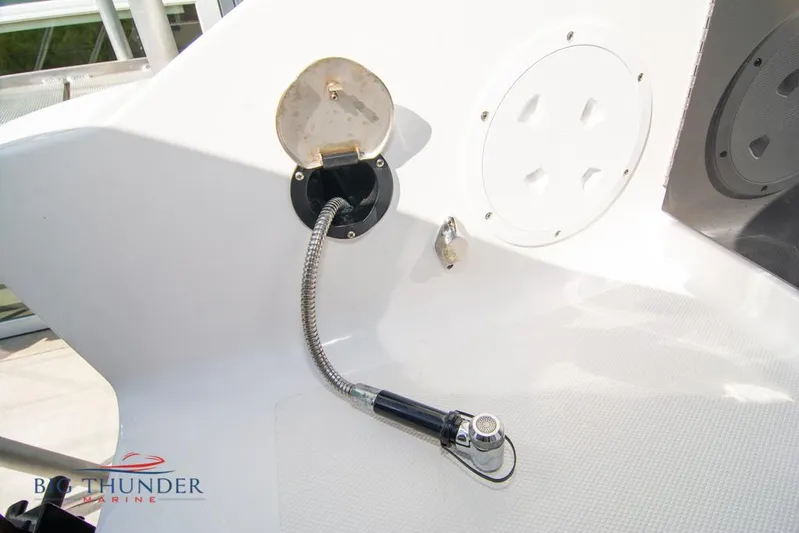  Yacht Photos Pics Fountain 32 NX 2022 boat deck with hose and outlet detail.