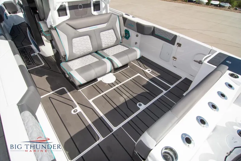  Yacht Photos Pics 2022 Fountain 32 NX boat interior with gray seating and Big Thunder Marine logo.