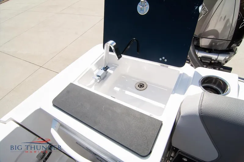  Yacht Photos Pics 2022 Fountain 32 NX boat sink and faucet with storage compartment.