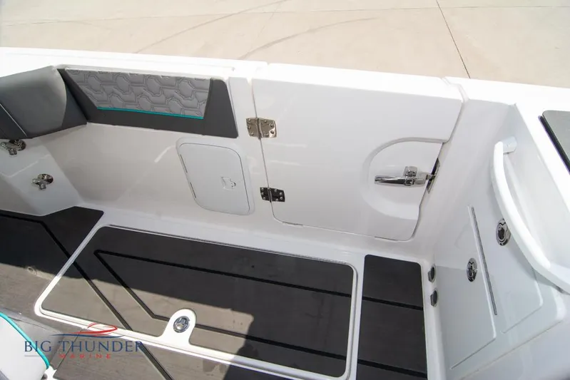  Yacht Photos Pics 2022 Fountain 32 NX boat interior with sleek seating and storage compartments.