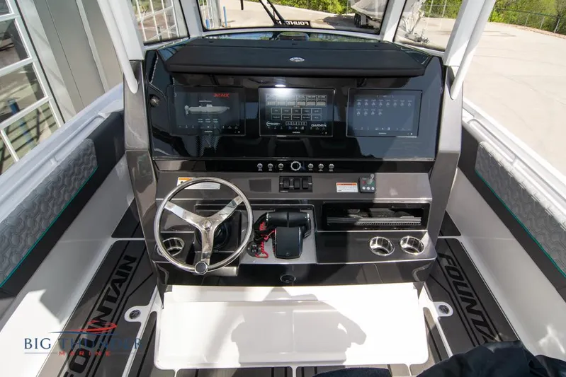  Yacht Photos Pics 2022 Fountain 32 NX boat dashboard with steering wheel and digital displays.