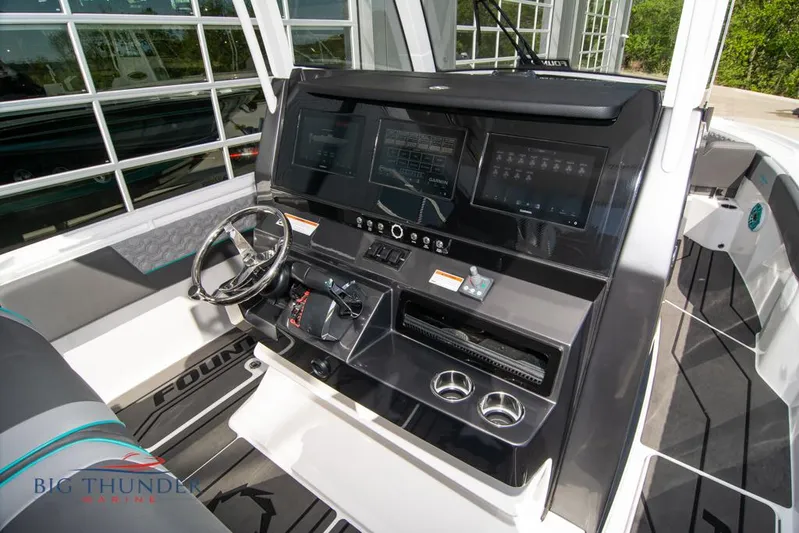  Yacht Photos Pics 2022 Fountain 32 NX boat dashboard with modern controls and steering wheel.