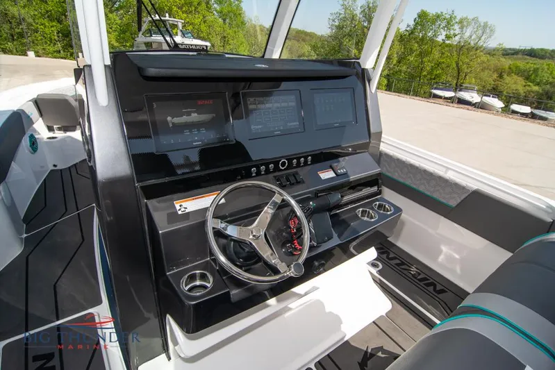  Yacht Photos Pics 2022 Fountain 32 NX boat dashboard with steering wheel and digital displays.