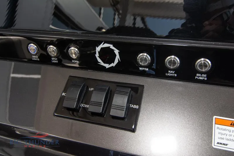  Yacht Photos Pics Control panel of a 2022 Fountain 32 NX boat with various switches and buttons.