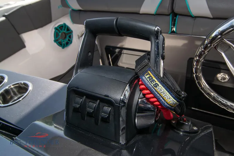  Yacht Photos Pics Throttle control and steering wheel of 2022 Fountain 32 NX boat interior.