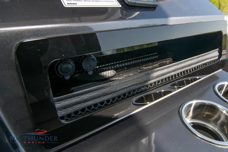  Yacht Photos Pics 2022 Fountain 32 NX dashboard with 12V outlets and cup holders.