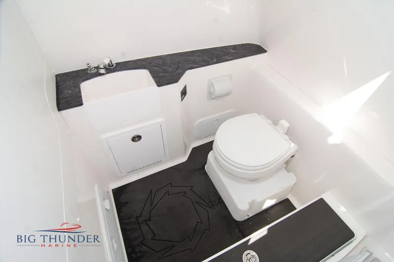  Yacht Photos Pics 2022 Fountain 32 NX boat bathroom with toilet, sink, and storage.