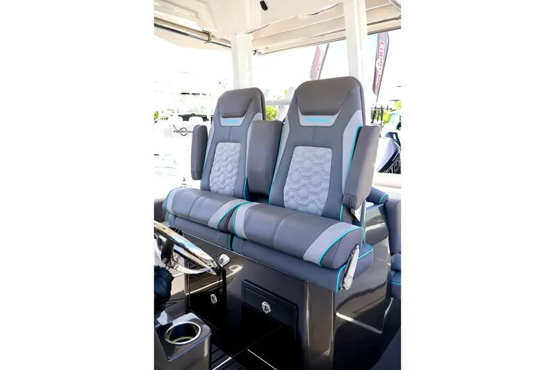  Yacht Photos Pics 2022 Fountain 32 NX boat seats with gray and teal accents, featuring modern design and comfort.