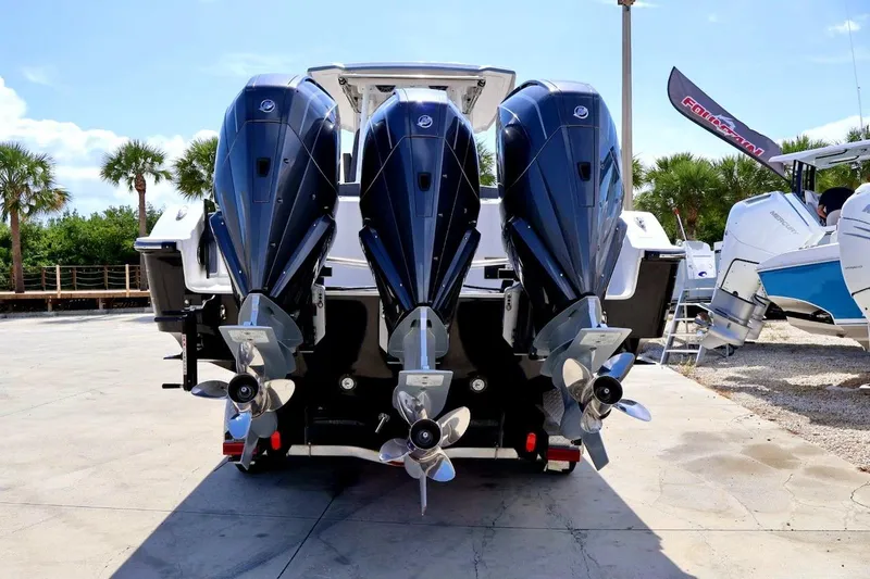  Yacht Photos Pics 2022 Fountain 32 NX boat with triple outboard engines, displayed outdoors.