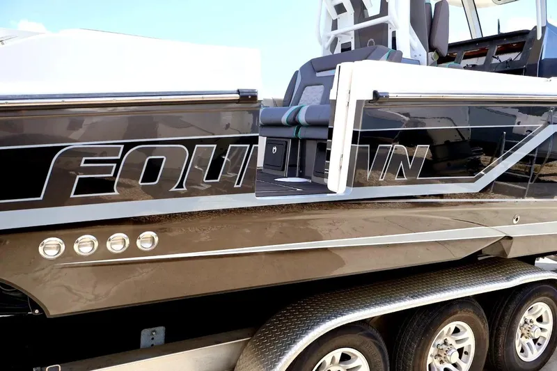  Yacht Photos Pics 2022 Fountain 32 NX boat with sleek design and open side door.