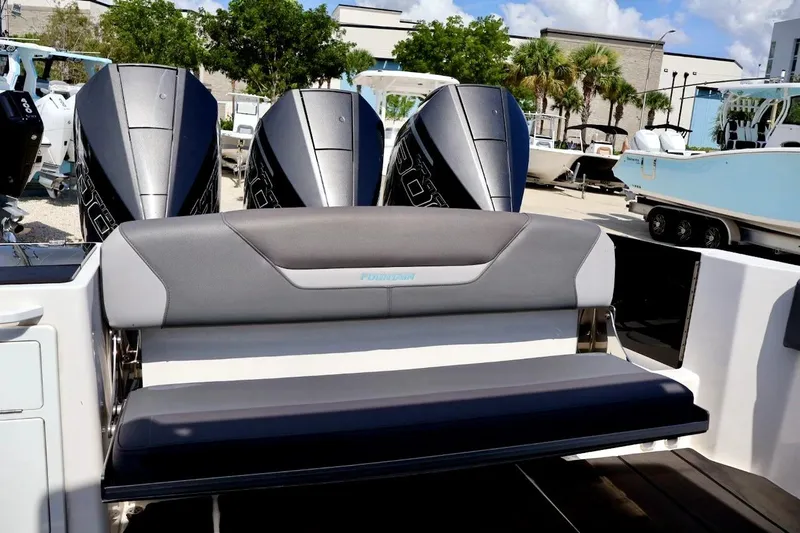  Yacht Photos Pics 2022 Fountain 32 NX boat with triple outboard engines and sleek seating.