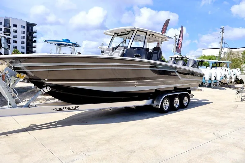  Yacht Photos Pics 2022 Fountain 32 NX boat on trailer, parked outdoors under a clear sky.