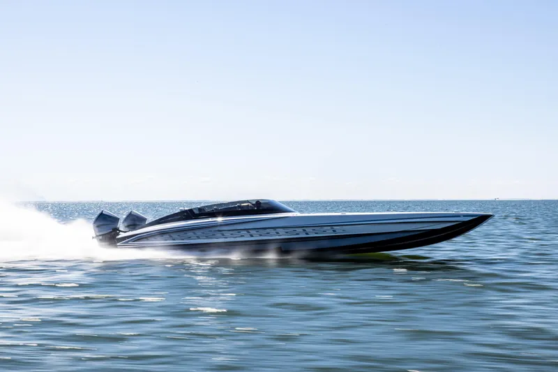  Yacht Photos Pics 2026 Mystic Powerboats C4000 speeding on open water under clear skies.