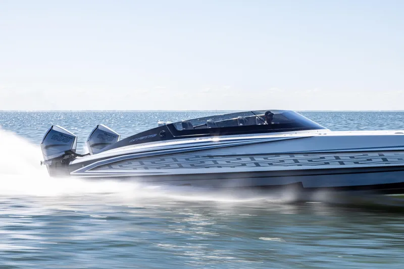  Yacht Photos Pics 2026 Mystic Powerboats C4000 speeding on open water, showcasing sleek design and powerful engines.