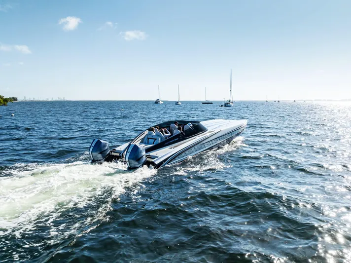  Yacht Photos Pics 2026 Mystic Powerboats C4000 cruising on open water under clear skies.