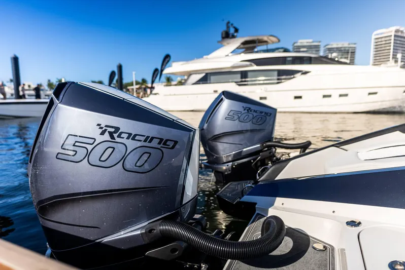  Yacht Photos Pics Twin Racing 500 engines on a 2026 Mystic Powerboats C4000, docked near a luxury yacht.