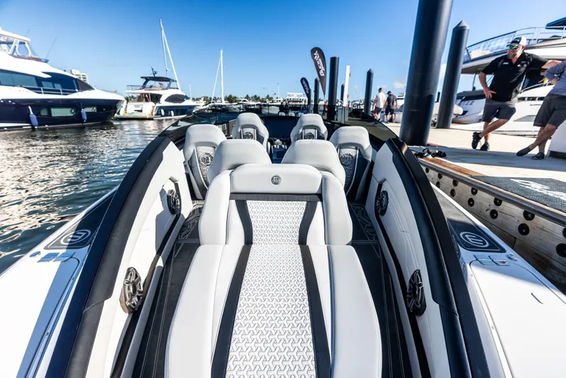  Yacht Photos Pics 2026 Mystic Powerboats C4000 luxury interior at marina, showcasing sleek design and premium seating.