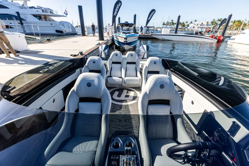  Yacht Photos Pics 2026 Mystic Powerboats C4000 luxury interior at marina, showcasing sleek design and seating.