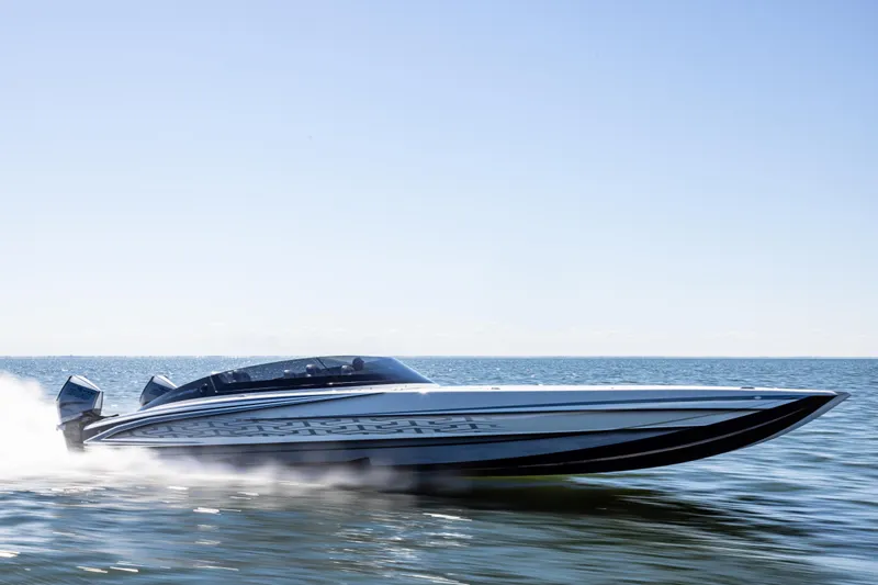  Yacht Photos Pics 2026 Mystic Powerboats C4000 speeding on open water under clear blue sky.