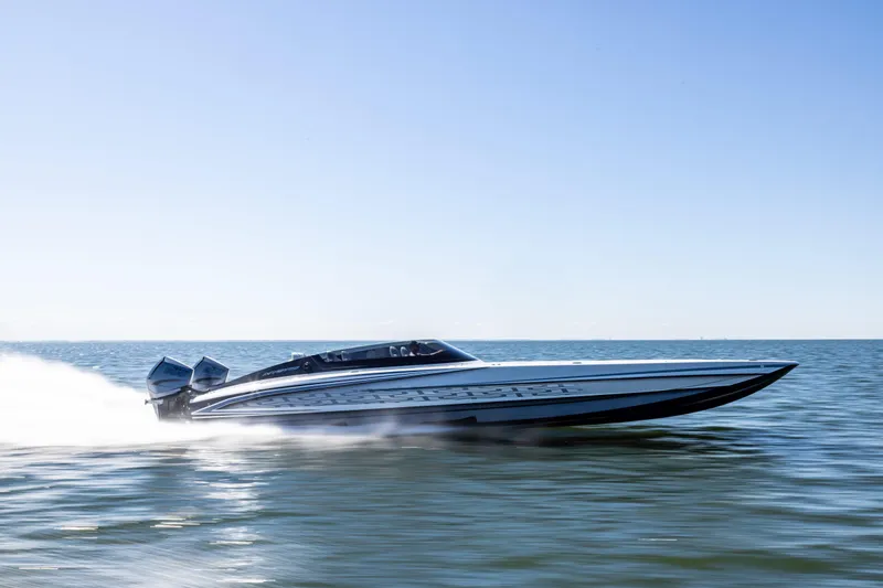  Yacht Photos Pics 2026 Mystic Powerboats C4000 speeding on open water under clear blue sky.