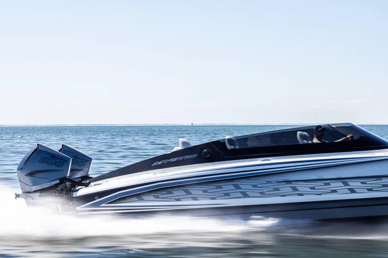  Yacht Photos Pics 2026 Mystic Powerboats C4000 speeding on open water, showcasing sleek design and powerful engines.
