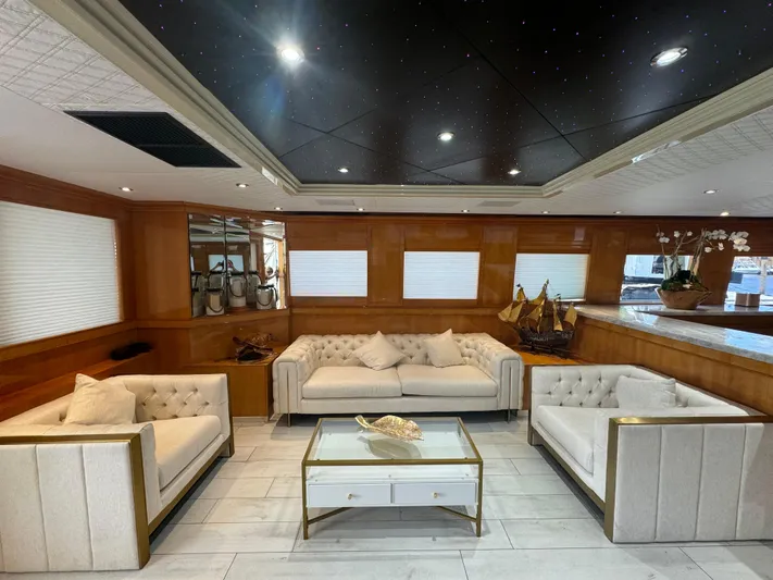  Yacht Photos Pics Luxurious interior of 2000 Baglietto 116 yacht with elegant seating and decor.