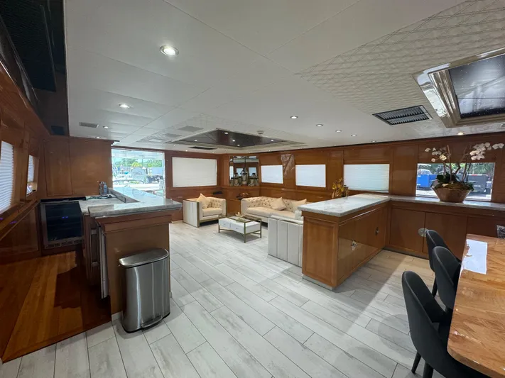  Yacht Photos Pics Luxurious interior of 2000 Baglietto 116 yacht with modern kitchen and seating area.