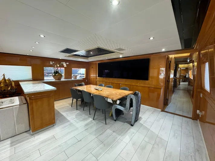  Yacht Photos Pics Luxurious interior of 2000 Baglietto 116 yacht with elegant dining area and modern decor.