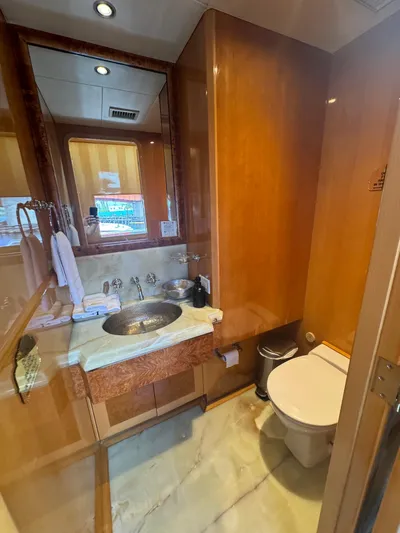  Yacht Photos Pics Luxurious bathroom on 2000 Baglietto 116 yacht with wood accents and modern fixtures.