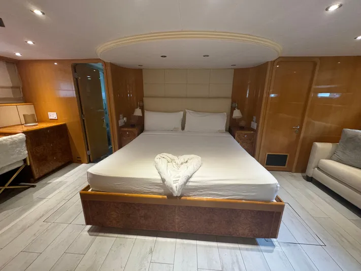  Yacht Photos Pics Luxurious bedroom interior on 2000 Baglietto 116 yacht with elegant wood finishes.