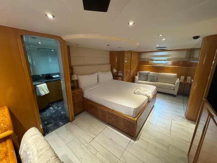 Yacht Photos Pics Luxurious bedroom interior of 2000 Baglietto 116 yacht with modern furnishings and en-suite bathroom.