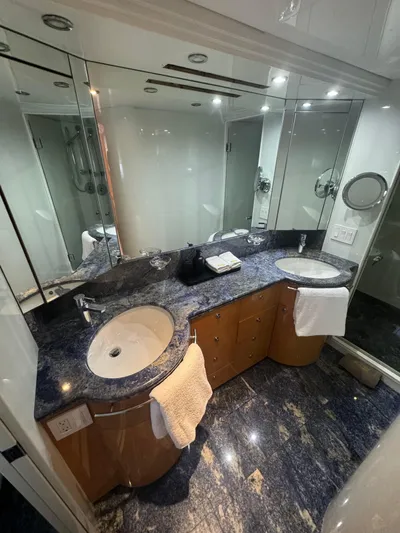  Yacht Photos Pics Luxurious bathroom on 2000 Baglietto 116 yacht with dual sinks and elegant marble countertops.