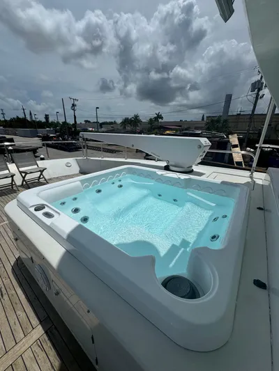  Yacht Photos Pics Jacuzzi on 2000 Baglietto 116 yacht deck under cloudy sky.