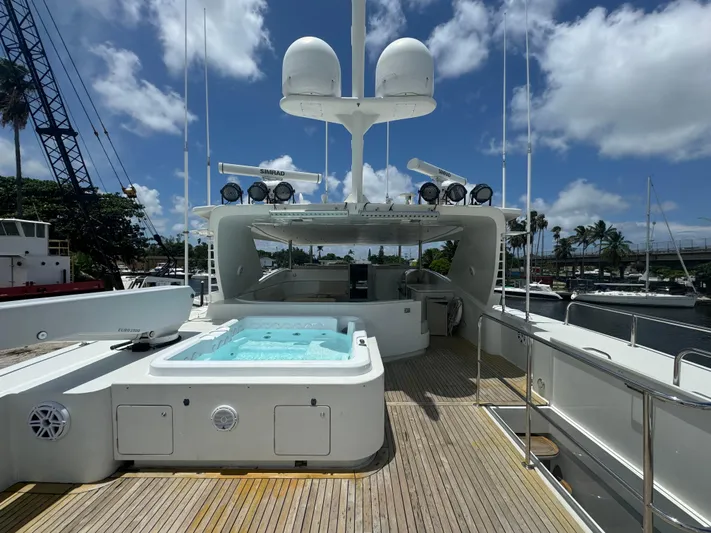  Yacht Photos Pics Luxurious 2000 Baglietto 116 yacht deck with hot tub and clear blue sky.