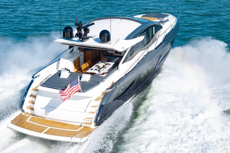 Kb Jr Yacht Photos Pics 2020 Sunseeker Predator 74 yacht cruising on open water with American flag displayed.