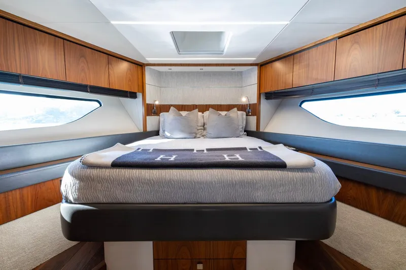 Kb Jr Yacht Photos Pics Luxurious bedroom interior of 2020 Sunseeker Predator 74 yacht with modern design and wood accents.